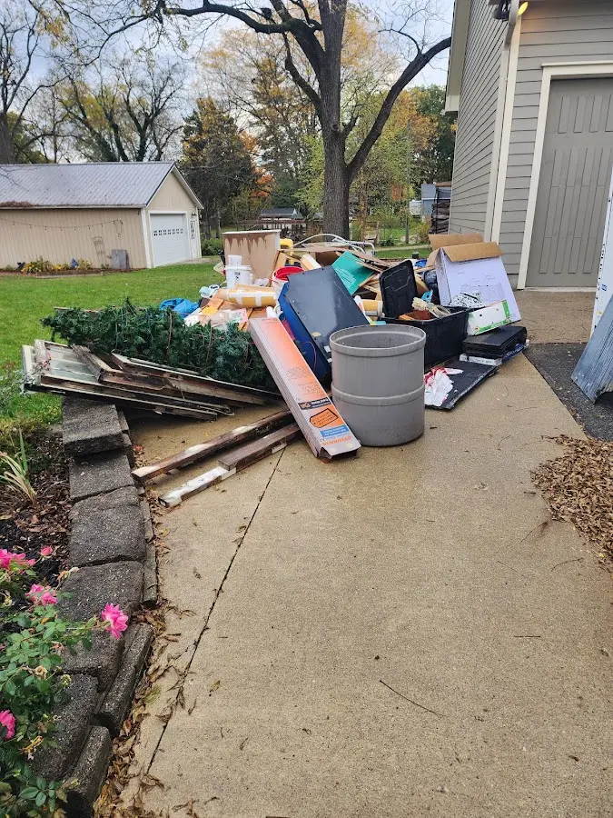 Dumpster being loaded with debris for Estate Cleanout Dumpster Rental in Comanche